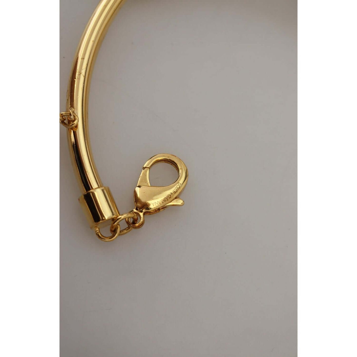 Close-up of Dolce & Gabbana gold choker with lobster clasp, showcasing elegant craftsmanship and luxurious design details.