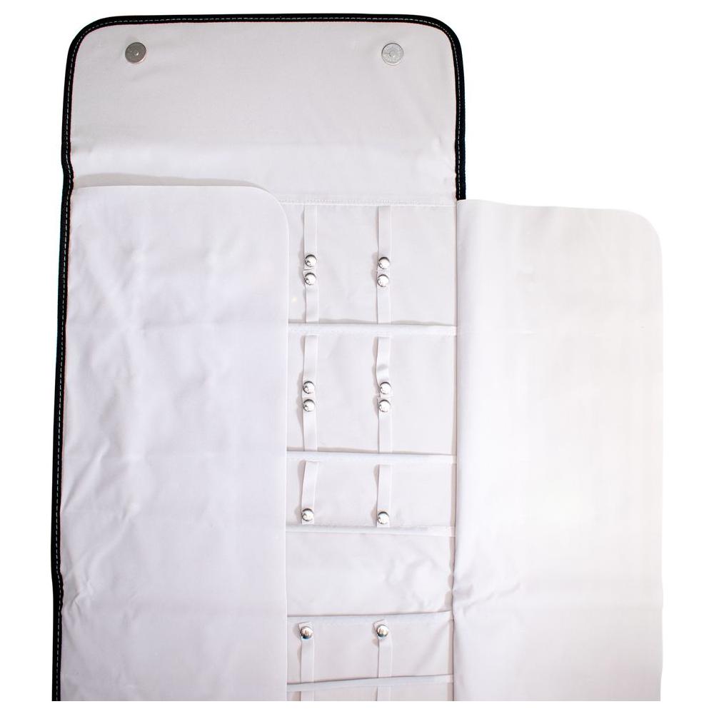 White fabric jewelry organizer with multiple snap closures for secure storage.