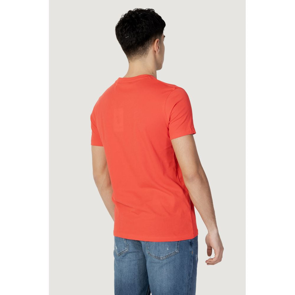 Back view of a man wearing a U.S. Polo Assn. red cotton t-shirt, showcasing the fit and style with blue jeans.