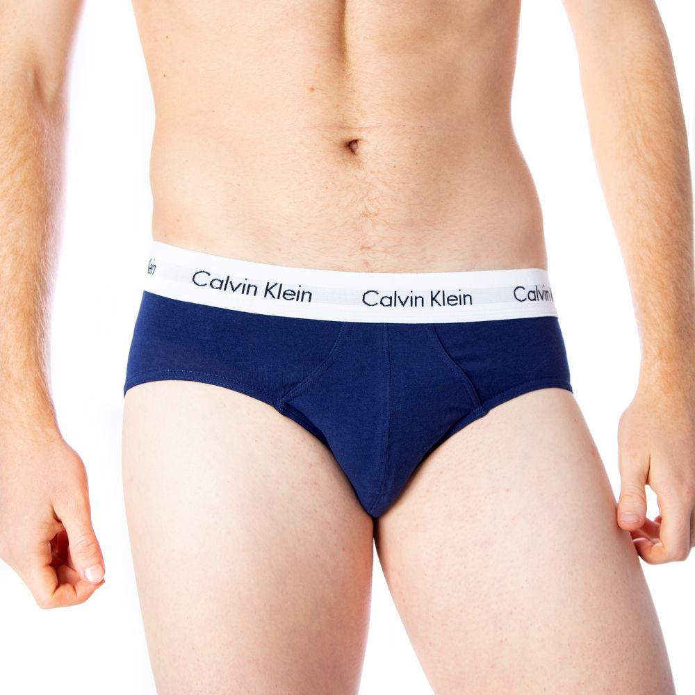 Man wearing blue Calvin Klein cotton briefs with logo waistband