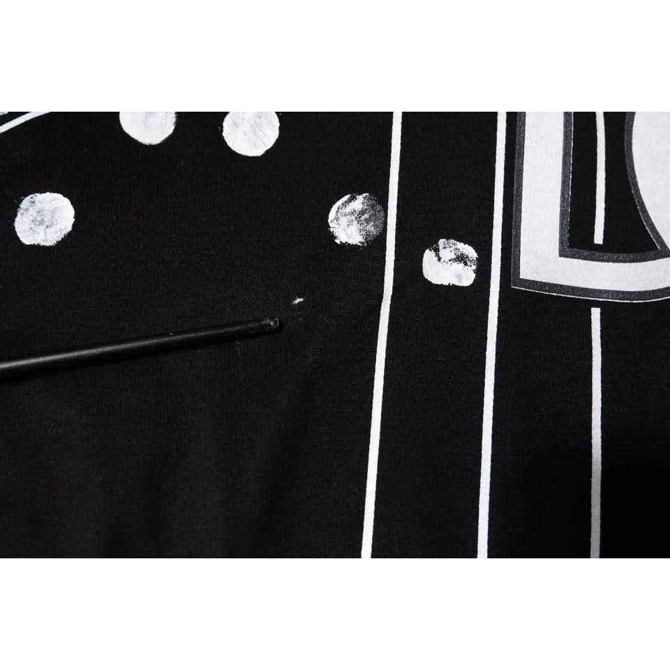 Close-up of Dolce & Gabbana black polka dots t-shirt showing minor discoloration and fabric detail.