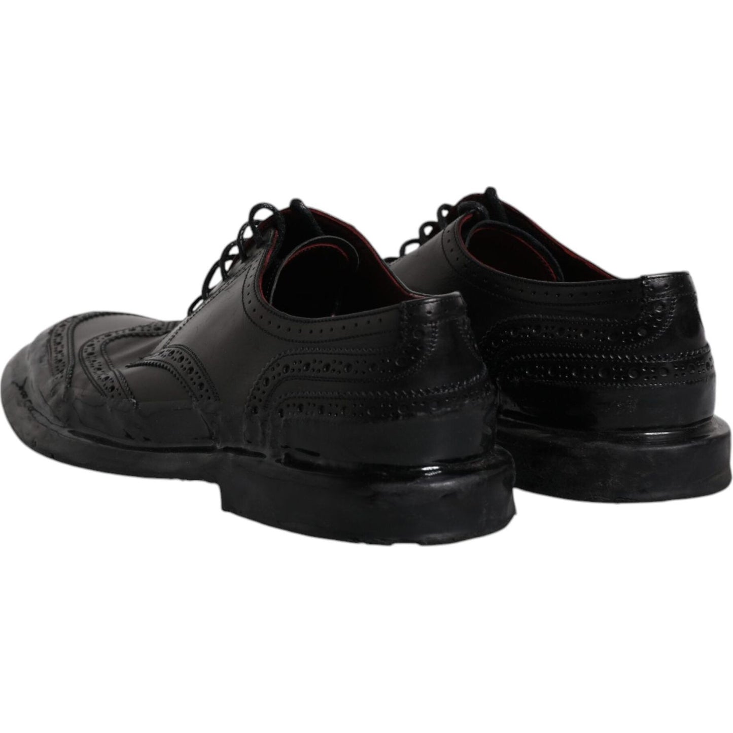 Dolce & Gabbana black leather derby wingtip formal shoes with intricate detailing and lace-up closure, made from premium calfskin leather.
