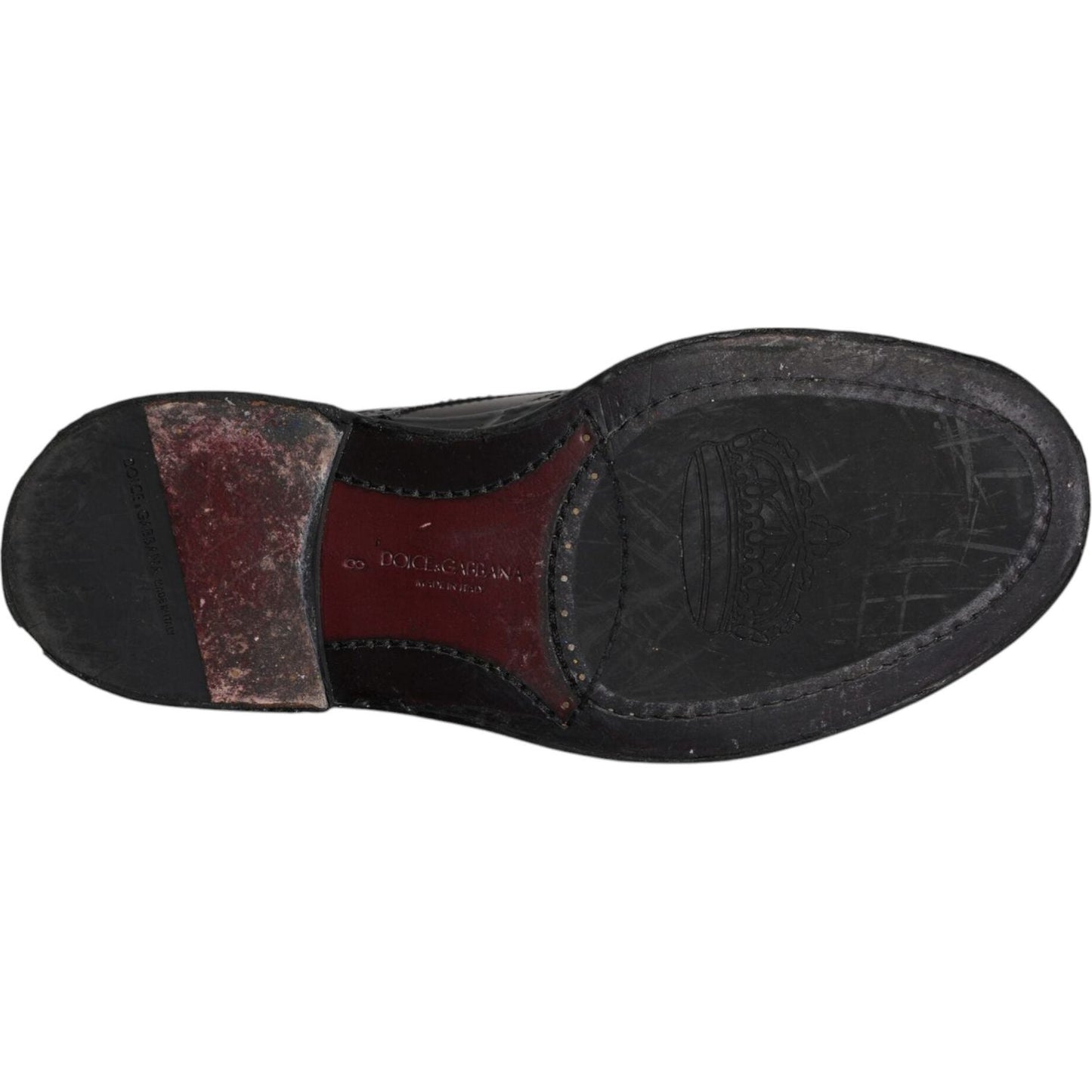 Sole view of Dolce & Gabbana black leather derby wingtip shoes, featuring calfskin material and brand detailing.