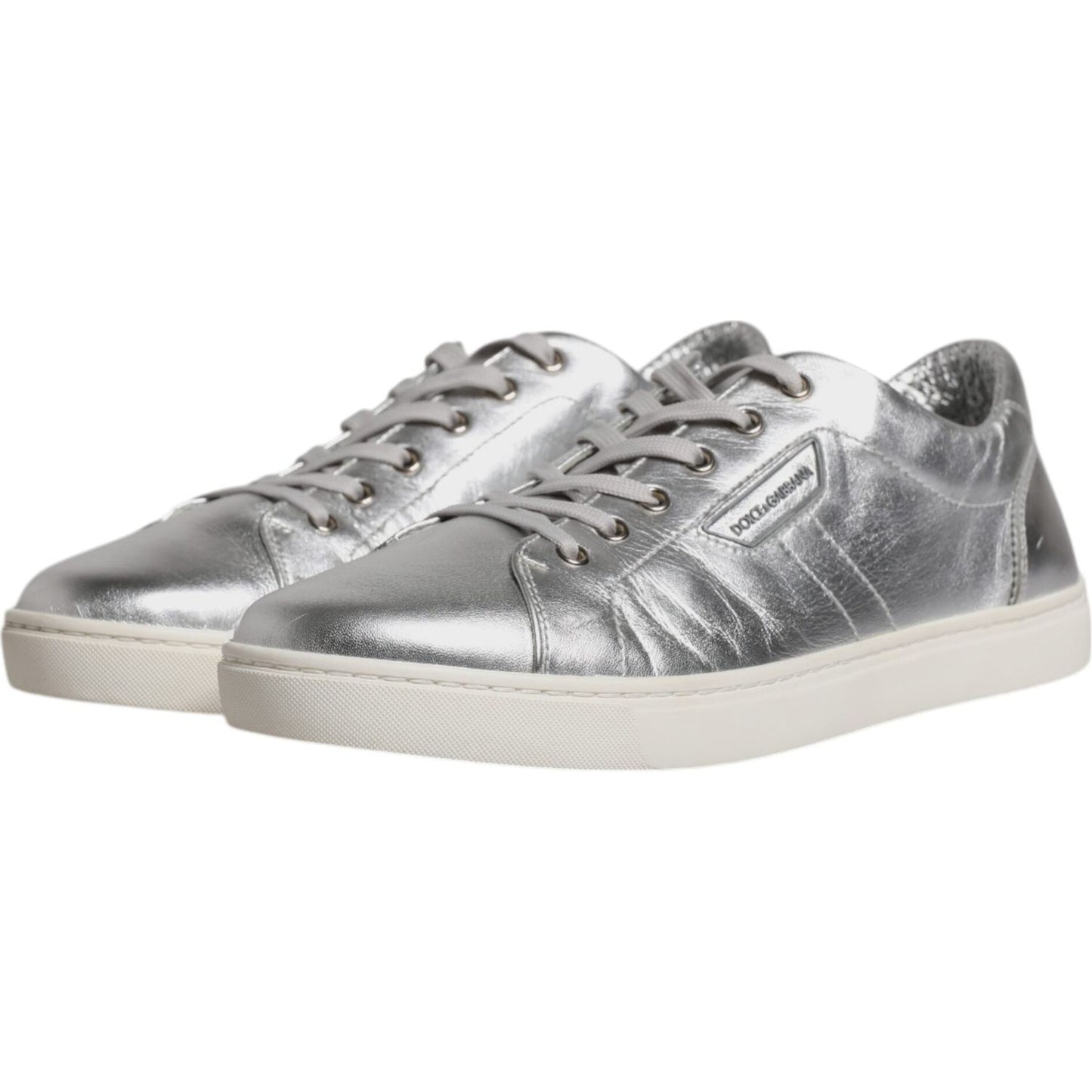 Dolce & Gabbana men's silver leather low top sneakers with rubber sole and lace-up closure, displaying logo details. Made in Italy.
