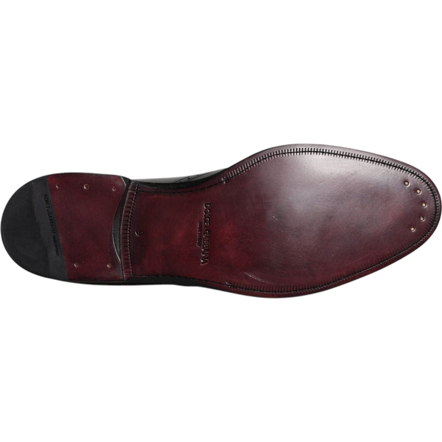 Underside view of Dolce & Gabbana black leather derby wingtip formal shoes, showcasing luxury leather sole and craftsmanship.
