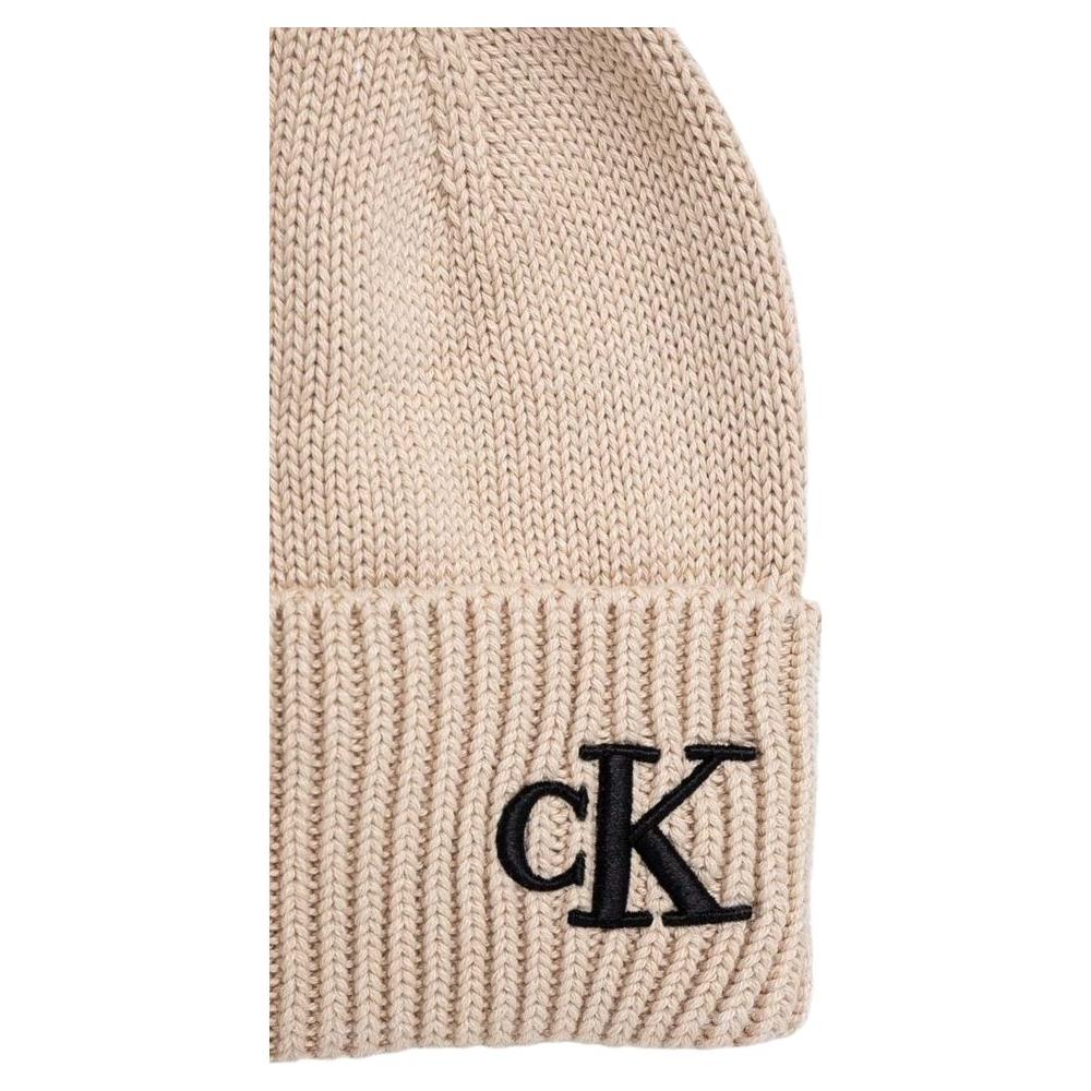Calvin Klein beige cotton acrylic beanie hat with black 'cK' logo embroidery and a cuffed design, winter fashion accessory.