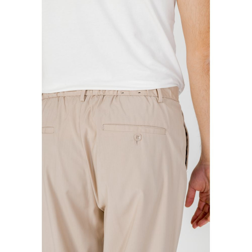 Back view of Antony Morato beige polyester men's pants from Spring/Summer collection, showcasing tailored fit and button details.