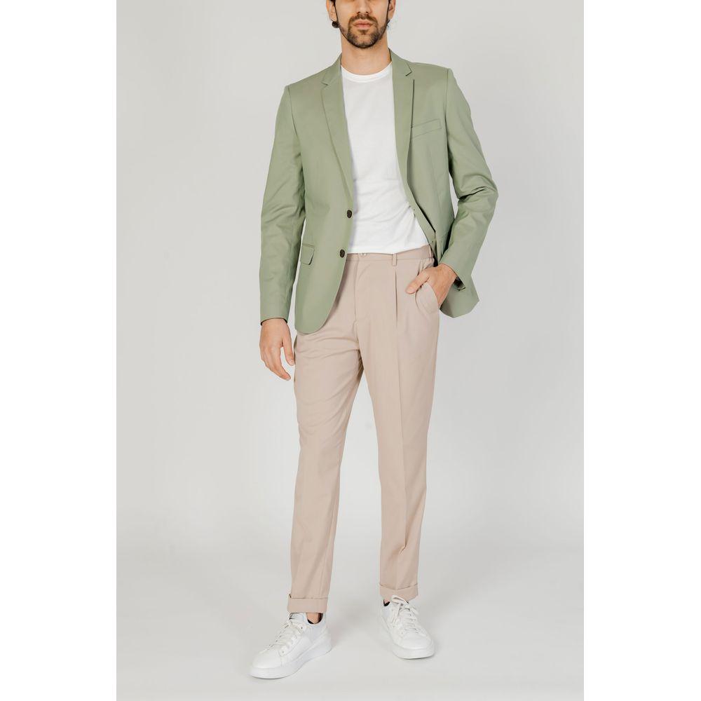 Man wearing Antony Morato beige polyester jeans and pants, paired with a green blazer and white sneakers, perfect for spring/summer.