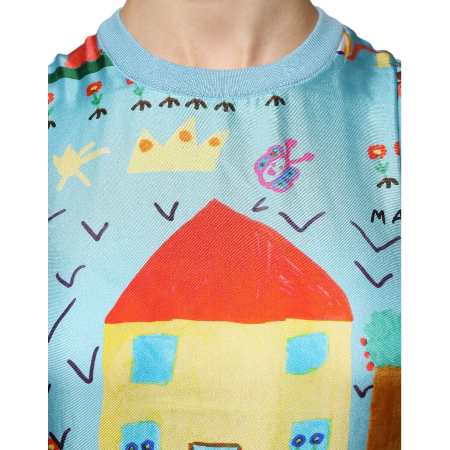 Close-up of Dolce & Gabbana sleeveless tank top in blue with colorful drawing print, highlighting unique design details.