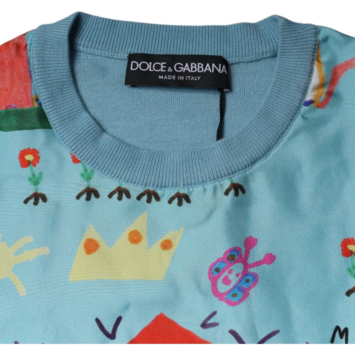 Dolce & Gabbana blue sleeveless tank top with artistic drawings, cashmere silk blend, made in Italy, close-up of neckline and logo.