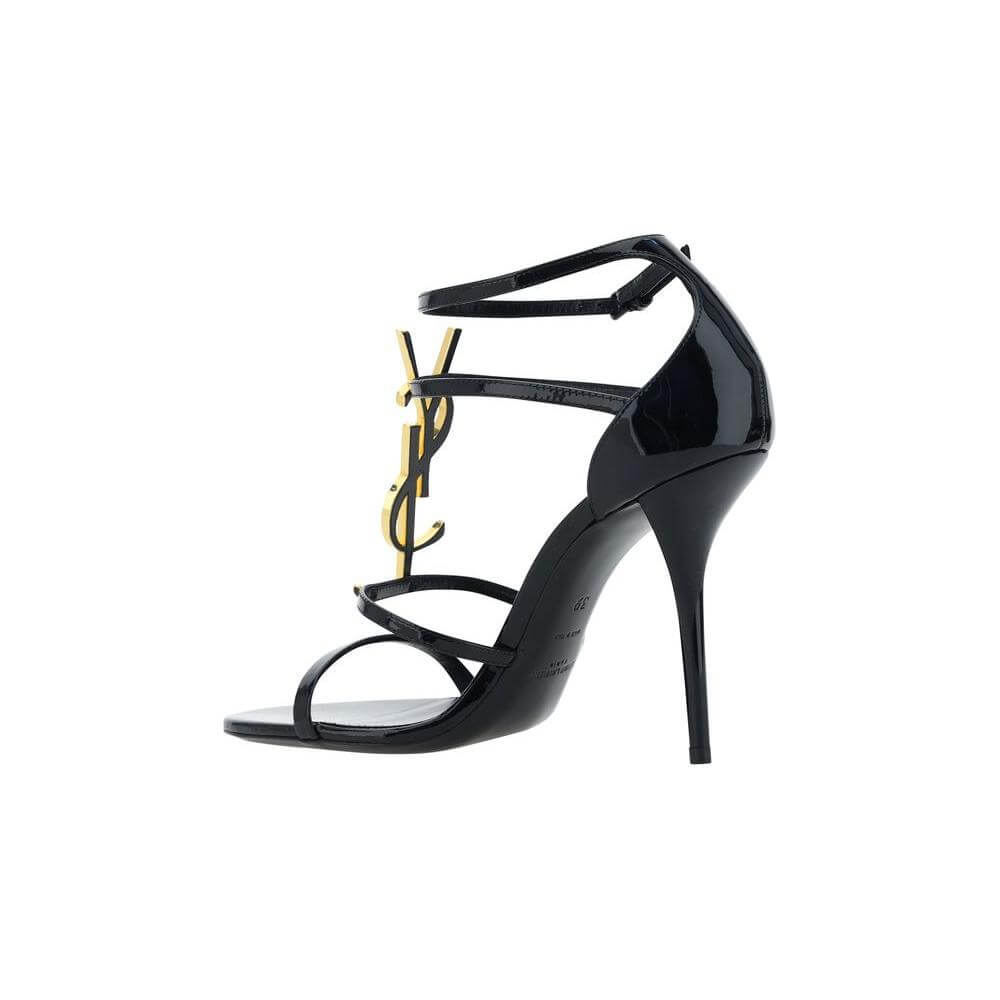 Saint Laurent Cassandra Sandals in black calfskin with YSL logo, open toe, adjustable ankle strap, and stiletto heel.