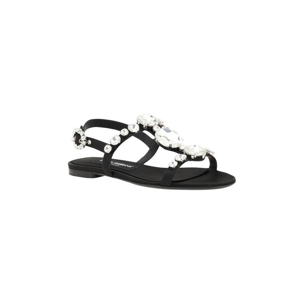 Dolce & Gabbana black jeweled sandals with caged design, almond toe, block heel, and jeweled buckle, offering both comfort and luxury.