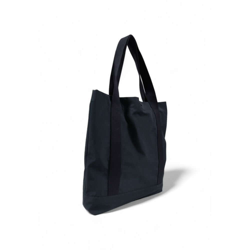 Black canvas tote bag with long handles on a white background, perfect for everyday use.