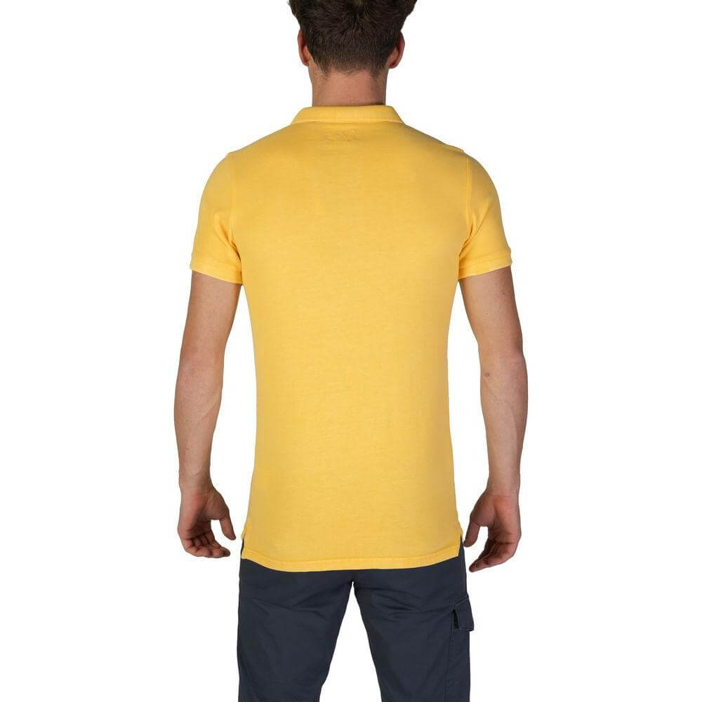 Back view of a man wearing a Superdry yellow cotton polo shirt, short sleeved, part of the Fall/Winter collection.