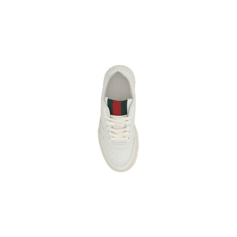Top view of Gucci Re-Web Sneakers in white leather with web applique on tongue, showcasing sporty elegance and perforated toe design.