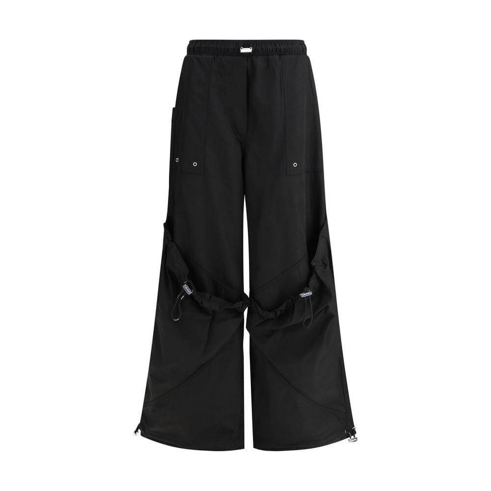 The Attico black nylon cargo pants with adjustable drawstring waistband, multiple pockets, and wide-leg design for urban style.
