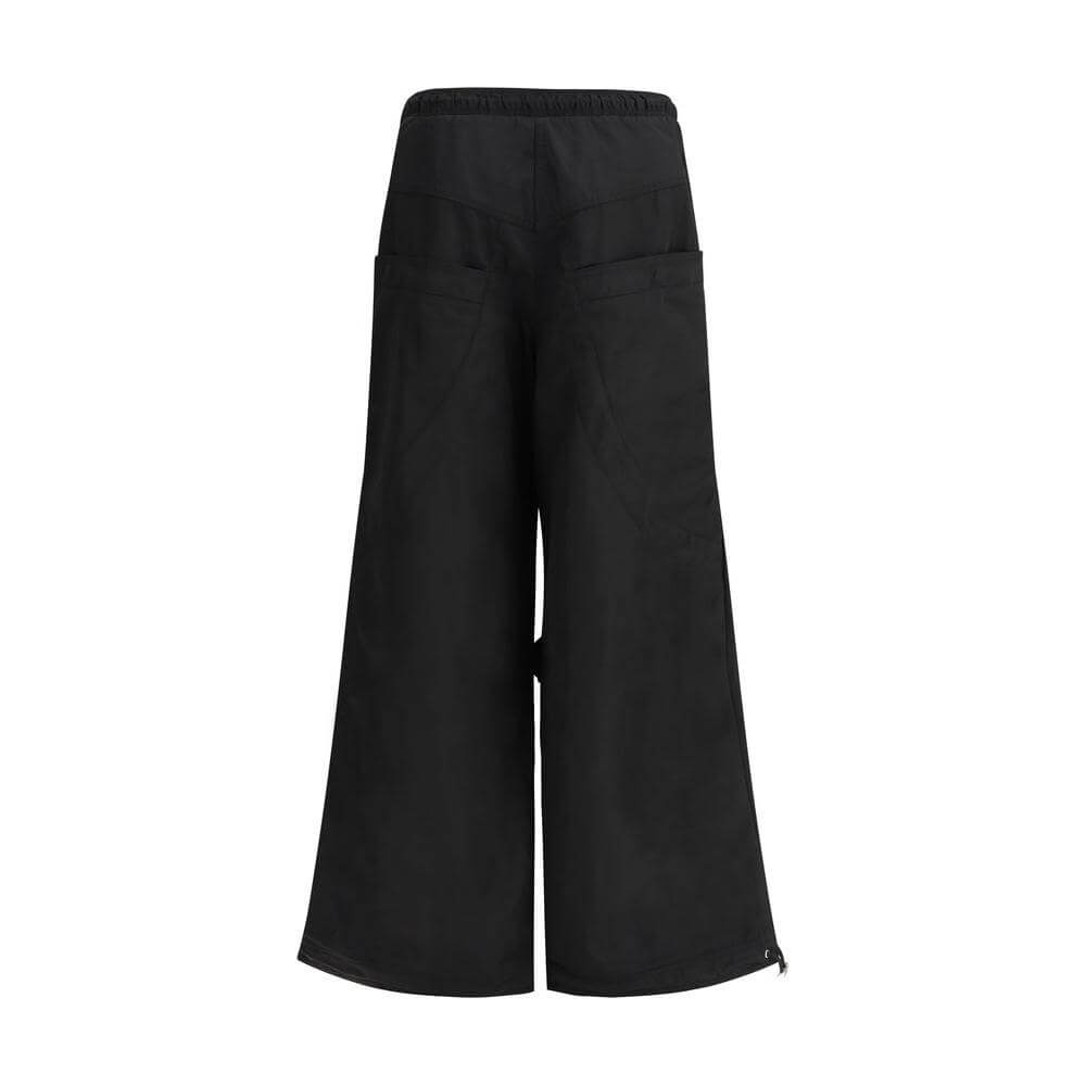 The Attico black nylon cargo pants with wide legs and back patch pockets, showcasing urban style and functionality.