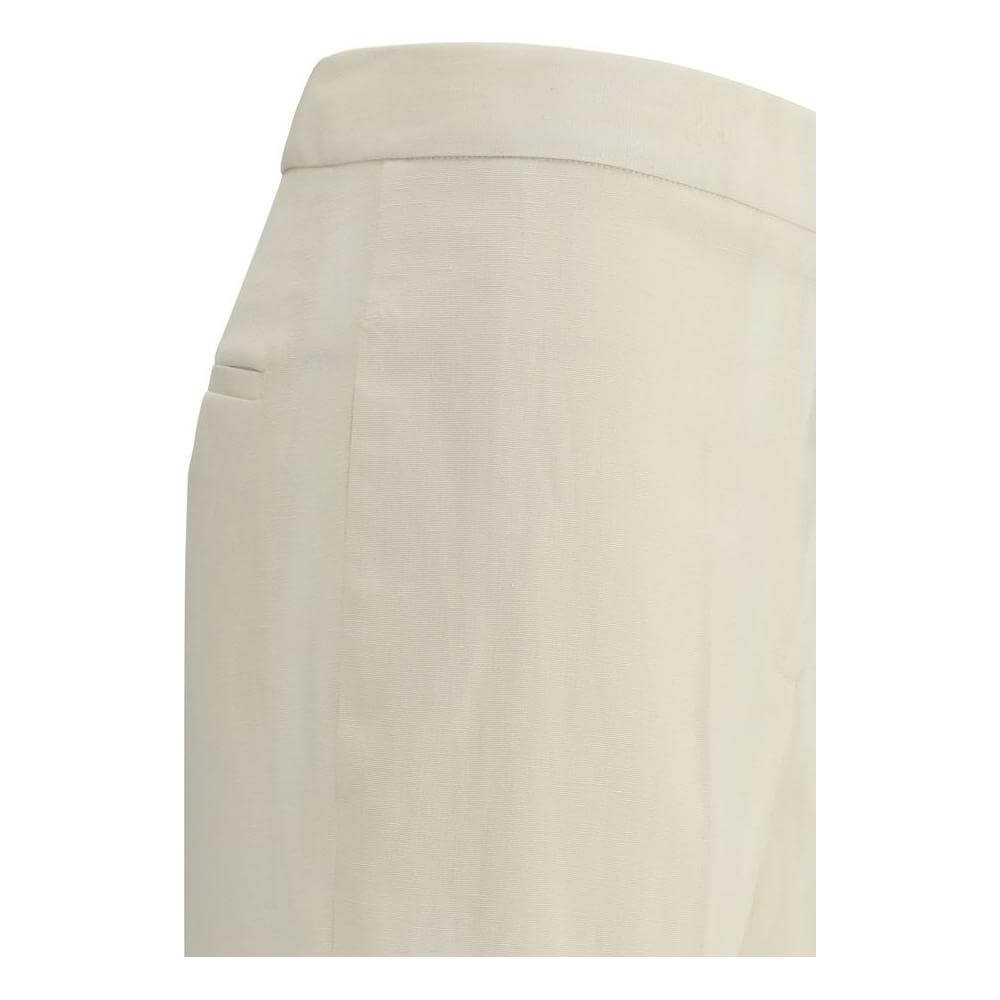 Side view of Fabiana Filippi virgin wool pants showing clean fit, mid-rise waist, and welt pocket detail in beige fabric.