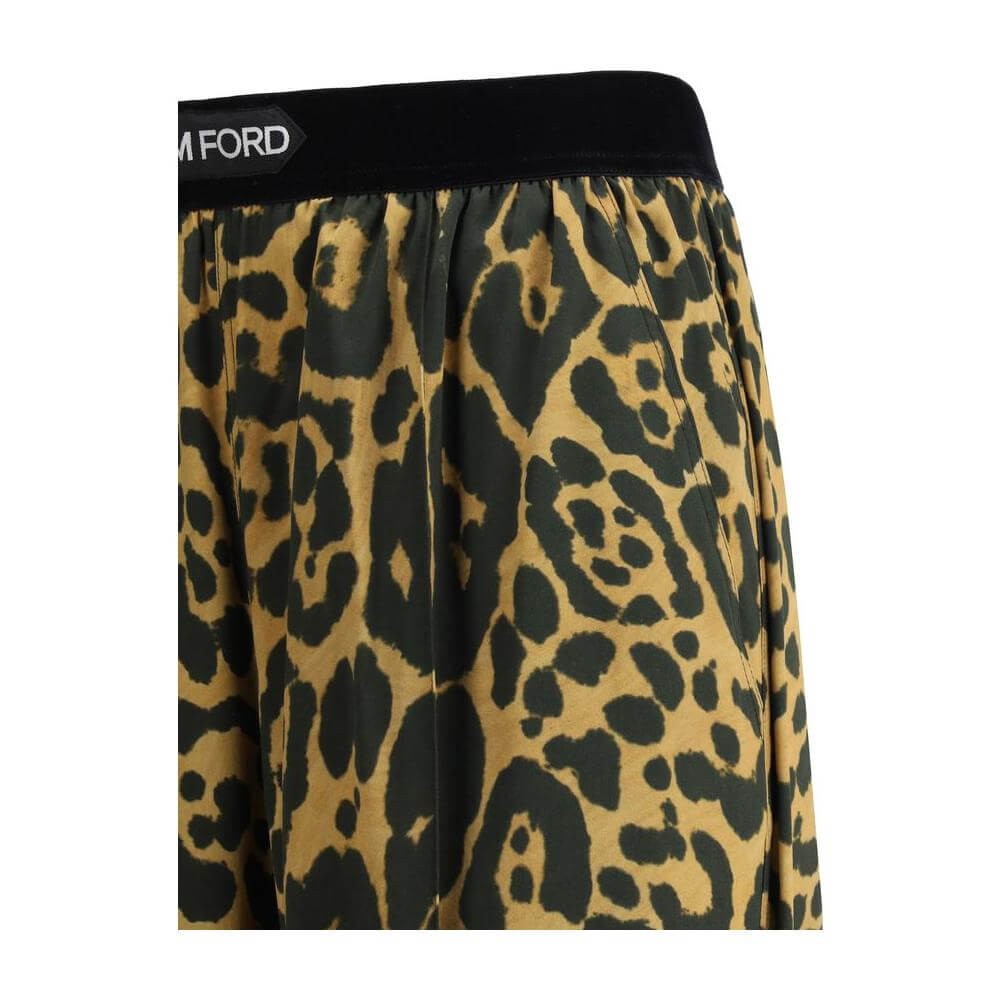Tom Ford silk pants with animal pattern and contrasting elastic waistband, featuring side welt and back patch slit pockets.