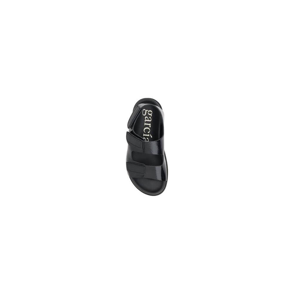 Top view of Pedro García Dinka Sandals in black leather with Velcro closure, showcasing the anatomical insole and refined round toe design.
