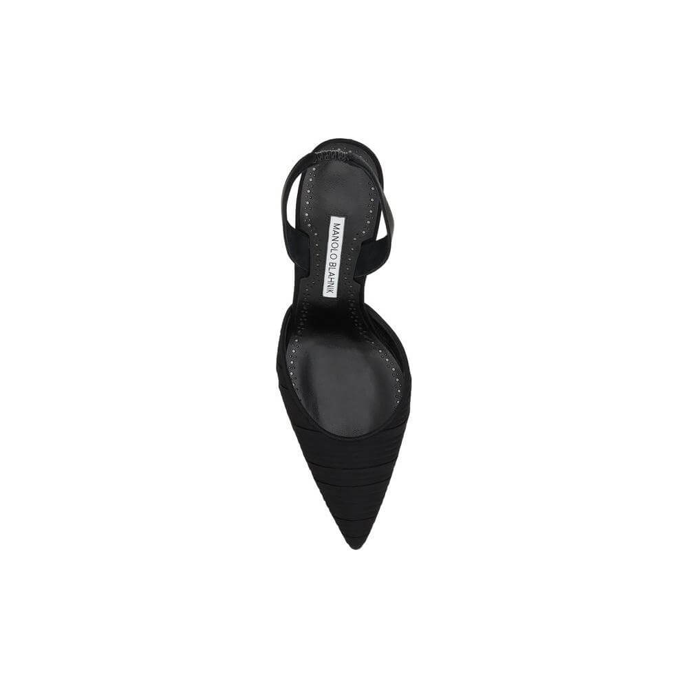 Top view of Manolo Blahnik Carolyne Pumps in black silk satin, featuring an elongated toe and logoed insole for elegant sophistication.
