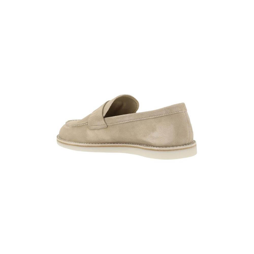 Side view of Prada suede loafers with almond toe and logo-embossed insole, featuring a modern flat sole. Perfect for a sophisticated look.