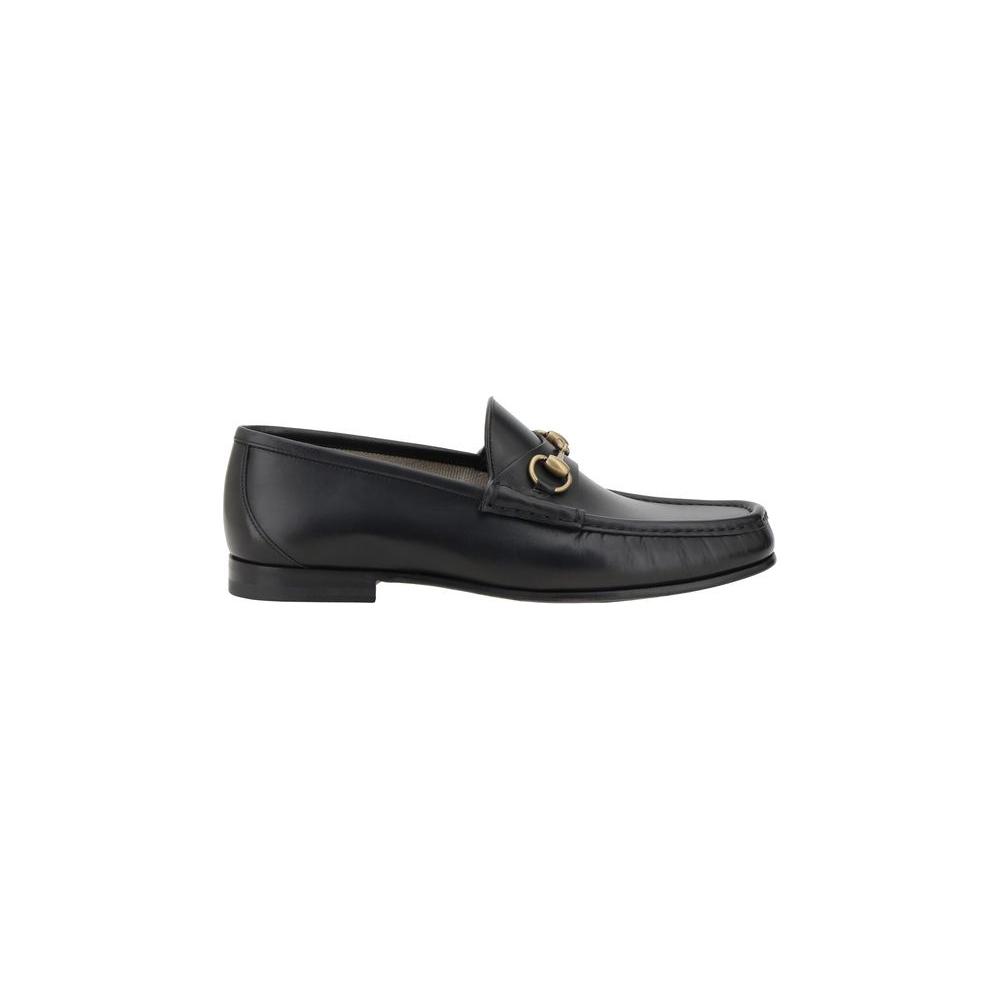 Gucci leather loafers with metallic horsebit detail, round toe, and leather block heel for chic sophistication.