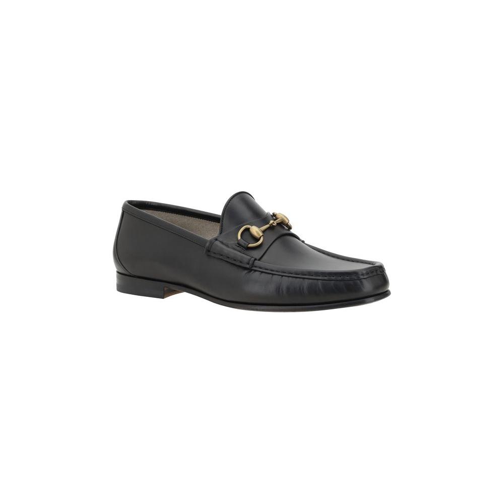 Gucci leather loafers with metallic horsebit detail, round toe, and leather block heel for elegant style and comfort.