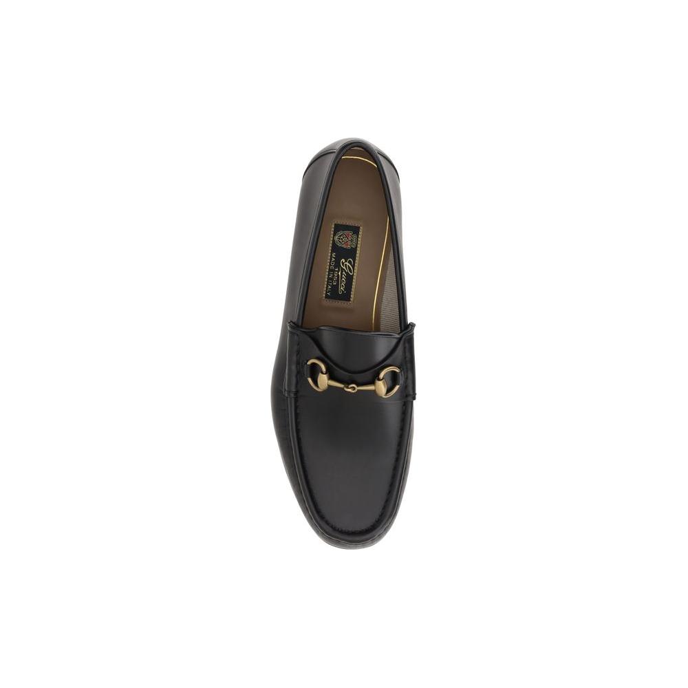 Gucci leather loafers with metallic horsebit detail, round toe, and logoed insole, perfect for a chic look.
