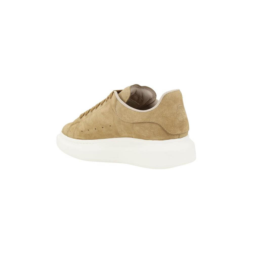 Alexander McQueen tan suede leather sneakers with platform sole and logoed heel label, showcasing modern elegance and bold design.