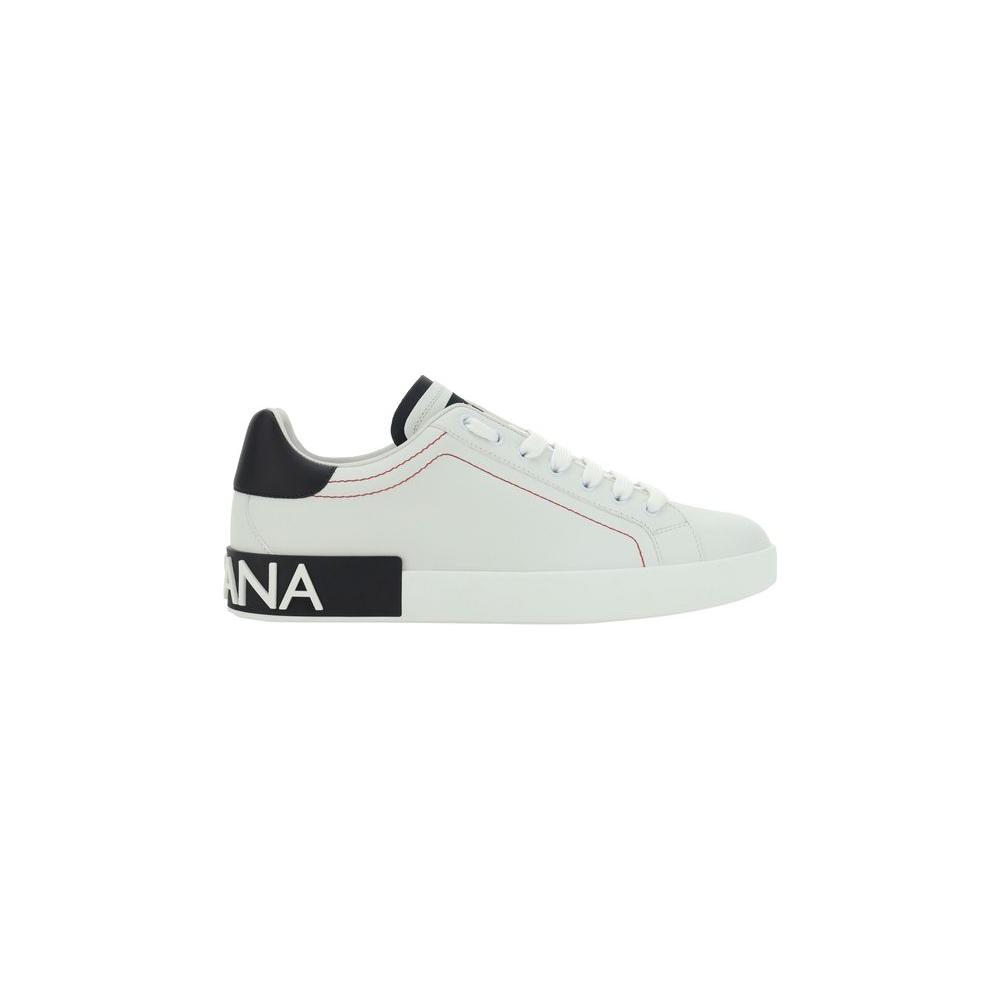 Dolce & Gabbana calfskin sneakers with lace-up front, raised sole, and brand embossed heel, featuring a contrasting logo patch on round toe.