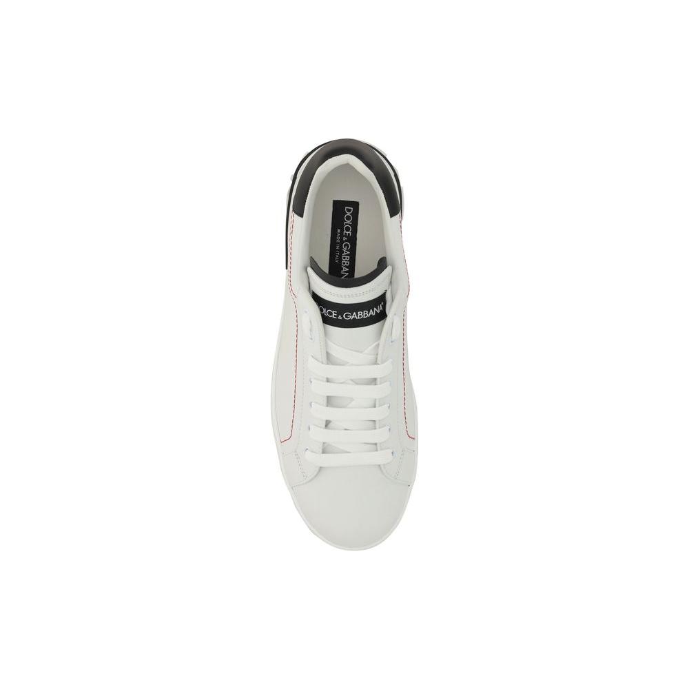 Top view of Dolce & Gabbana white calfskin sneaker with lace-up closure, embossed heel branding, and embroidered front logo patch.
