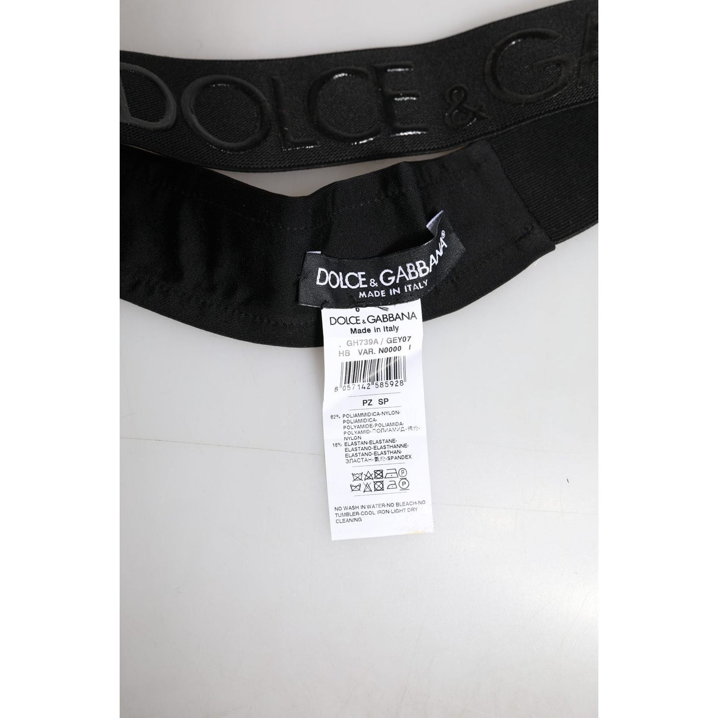 Dolce & Gabbana black men's head band with DG logo, made in Italy, nylon and elastane material, showing product label and tag.