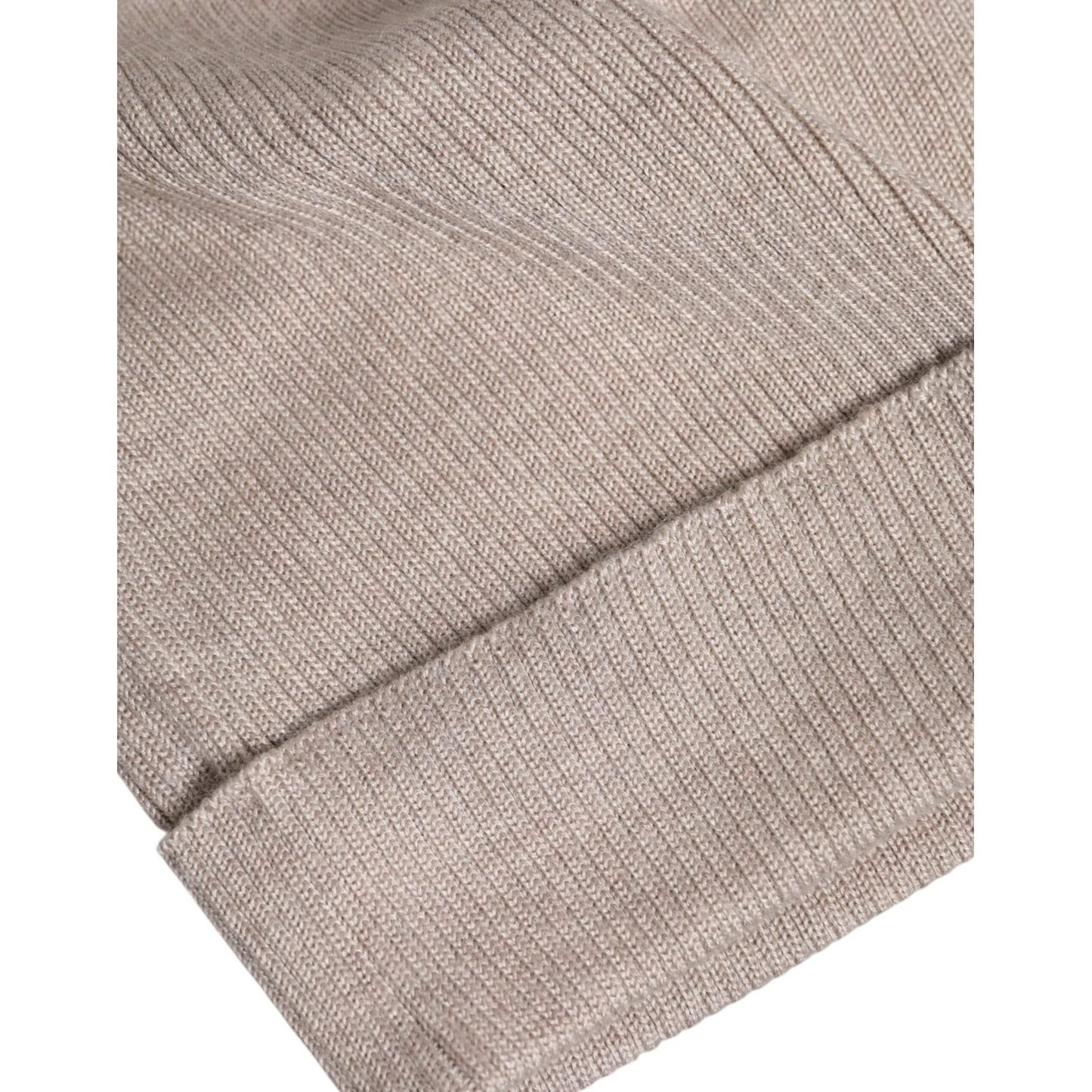 Close-up of Dolce & Gabbana beige cashmere knitted winter beanie hat, showcasing premium quality material and craftsmanship.