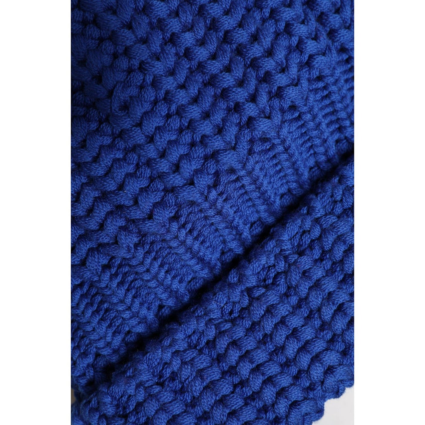 Close-up of blue Dolce & Gabbana knit winter beanie hat made from 100% virgin wool, showcasing intricate texture and stitching.
