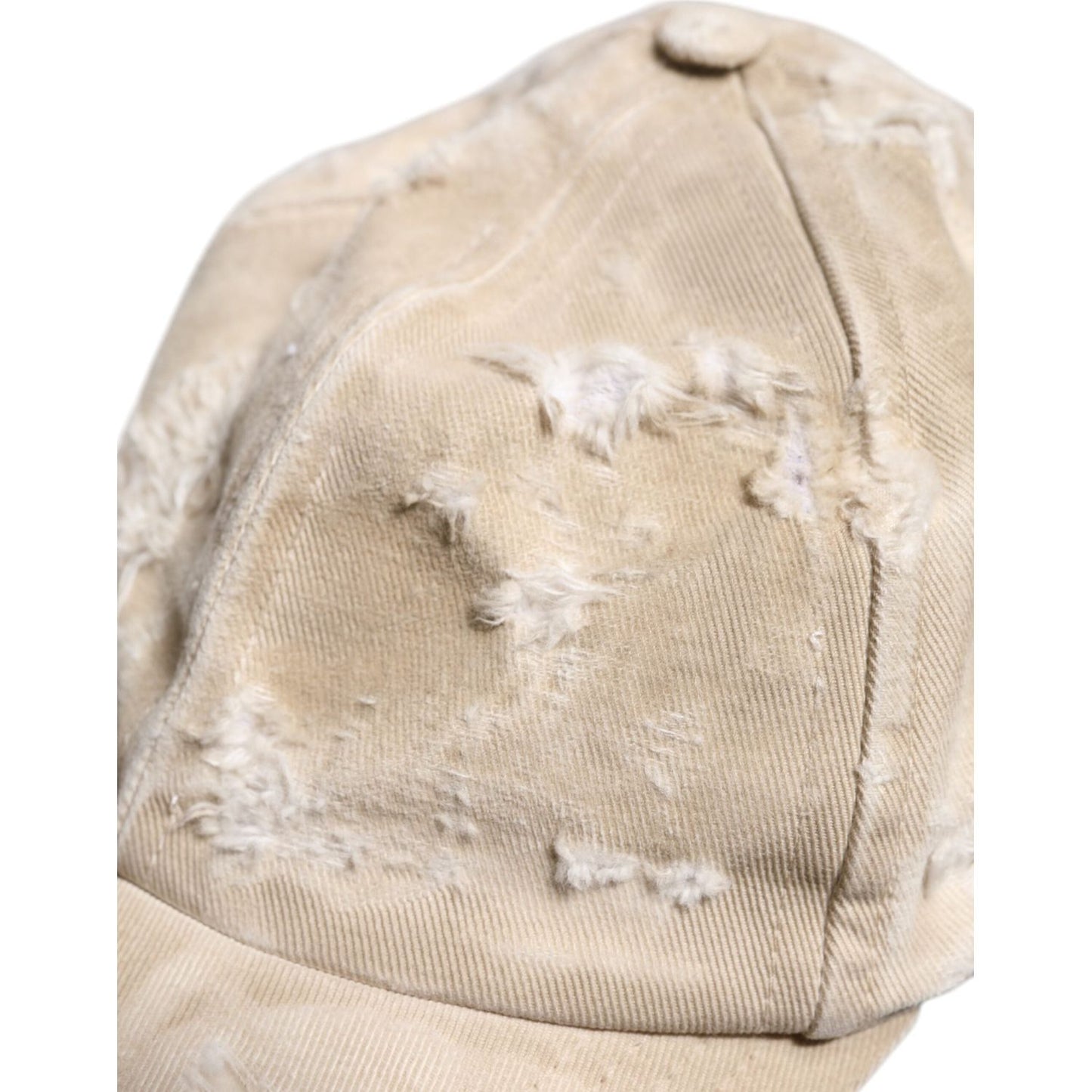 Dolce & Gabbana beige tattered cotton baseball cap, close-up view showing texture and quality stitching, made in Italy.