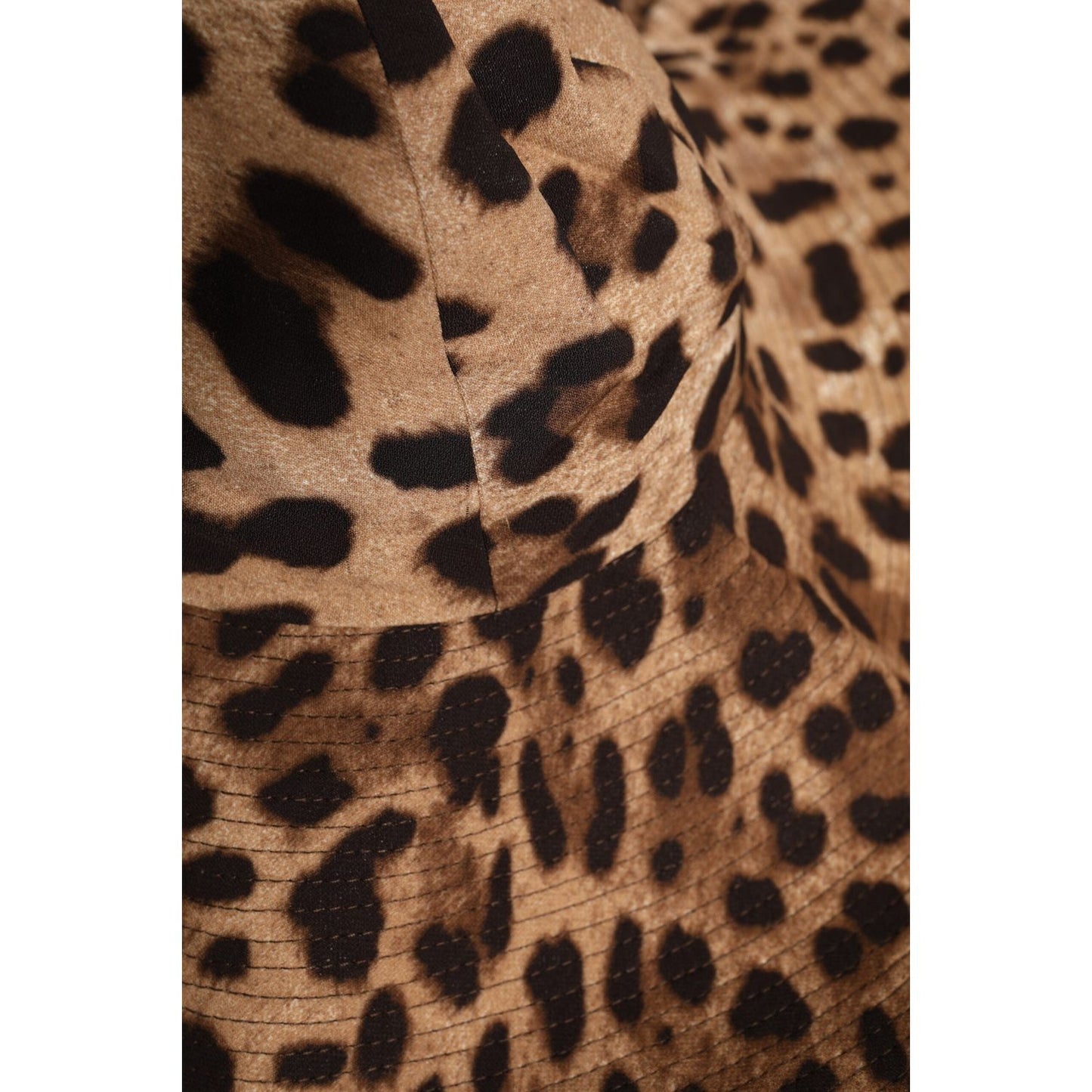 Dolce & Gabbana brown leopard print viscose women's bucket hat close-up, showcasing fabric texture and pattern details.
