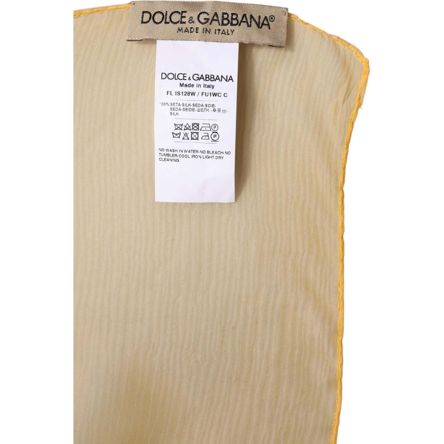 Dolce & Gabbana yellow silk shawl scarf label, showcasing 100% Italian craftsmanship and luxury fashion details.