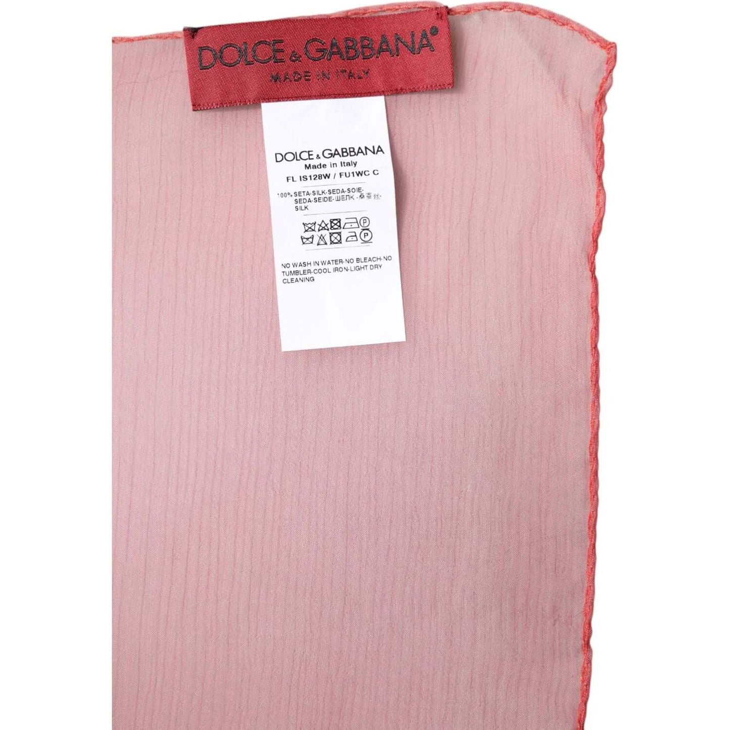 Dolce & Gabbana pink silk scarf tag and fabric details showing Made in Italy label and care instructions.