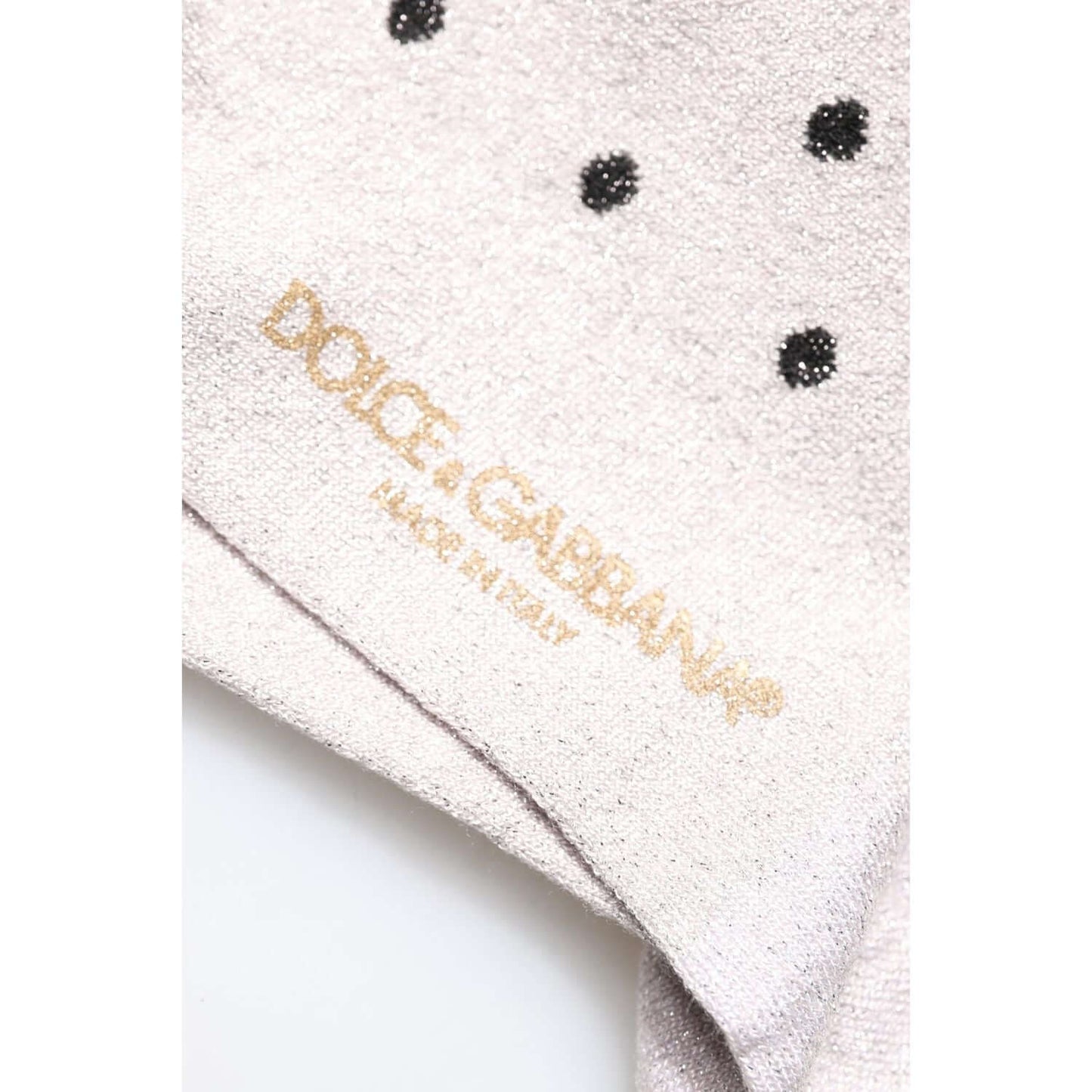 Close-up of Dolce & Gabbana gray dotted viscose socks with logo, showcasing high-quality Italian craftsmanship.