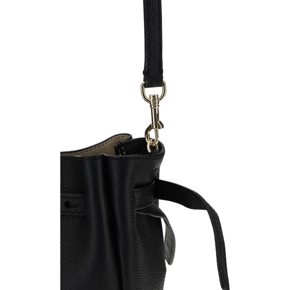 Close-up of Tory Burch Romy Smartphone Shoulder Case with fine grained leather and thin belt detail, featuring an adjustable strap.