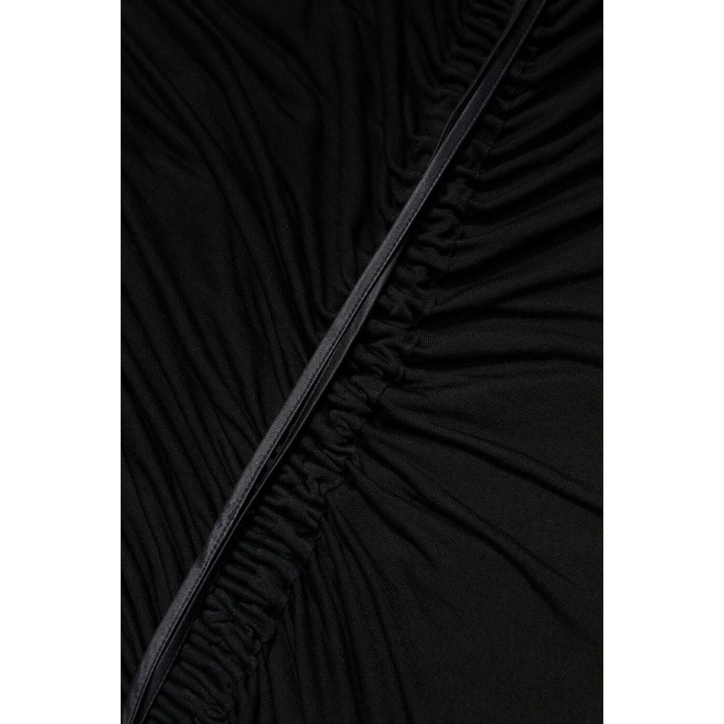 Close-up of Dolce & Gabbana black tulle material with mesh trim detailing, showcasing high-end craftsmanship and elegant texture.