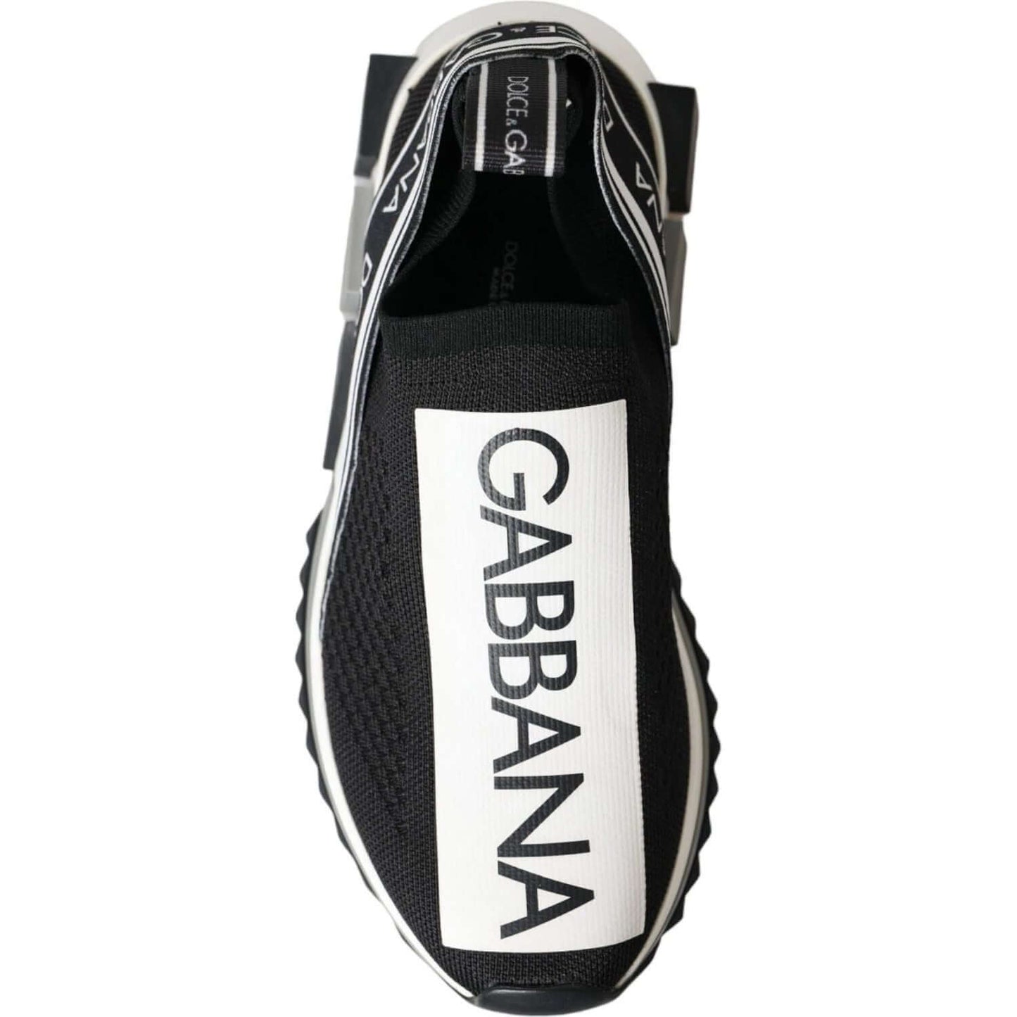 Top view of Dolce & Gabbana Sorrento black and white slip-on sneakers with logo print and rubber sole.