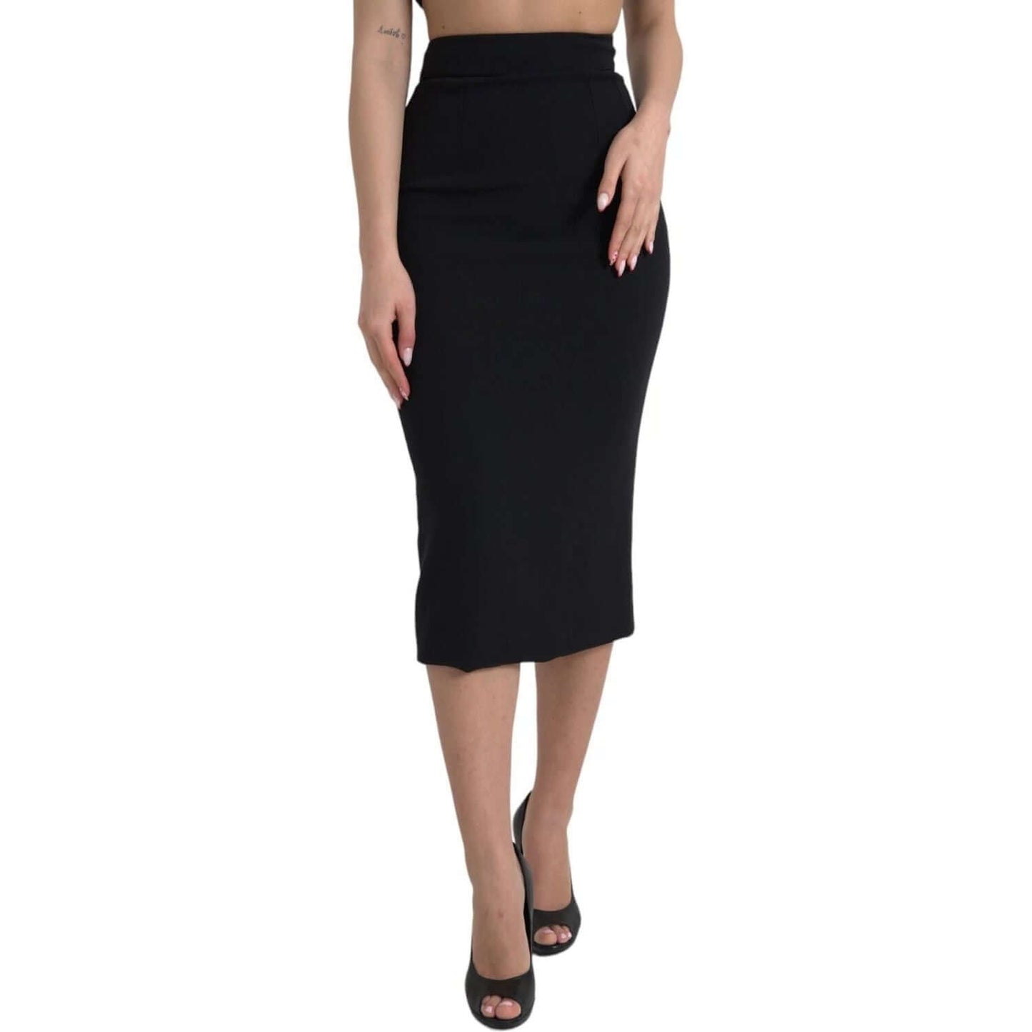 Dolce & Gabbana black wool high waist pencil cut midi skirt featuring back zipper and logo details, shown on model.