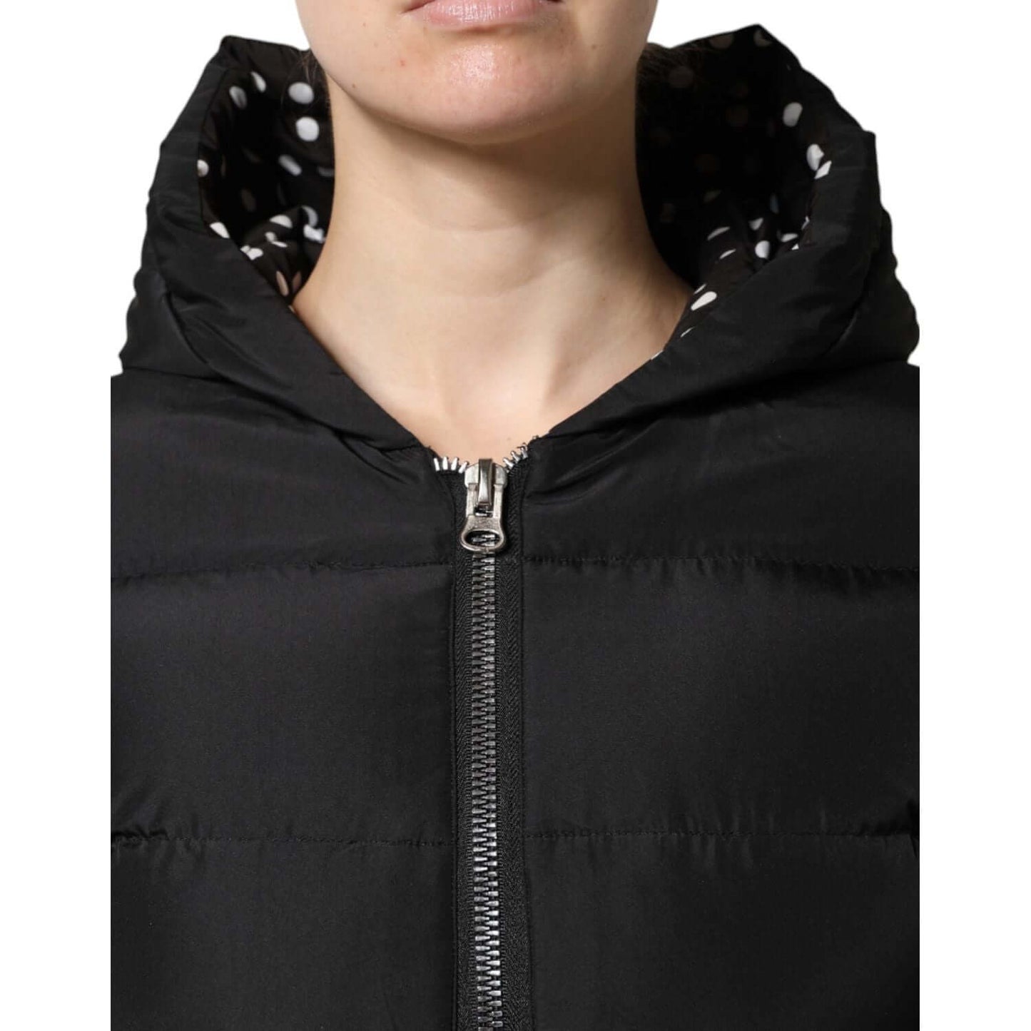 Dolce & Gabbana black puffer hooded reversible jacket with zip closure, showcasing inner polka dot lining. High-quality Italian craftsmanship.