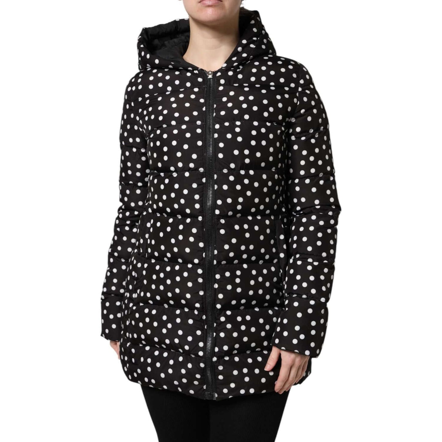 Black and white polka dot puffer hooded jacket with zip closure, showcasing a reversible design and long sleeves.