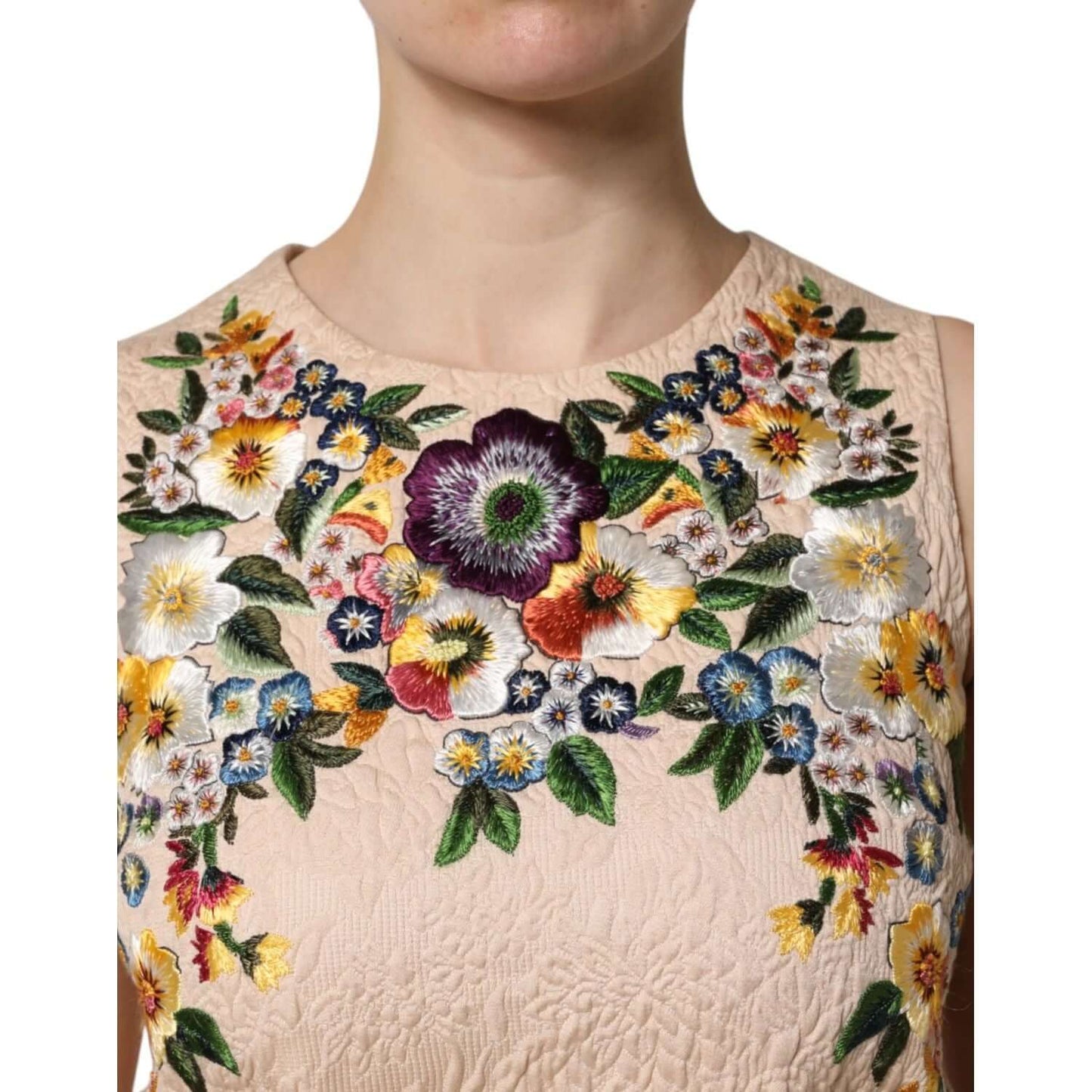 Dolce & Gabbana beige sleeveless tank top with vibrant floral embroidery, crafted in Italy from cotton and nylon for elegant style.