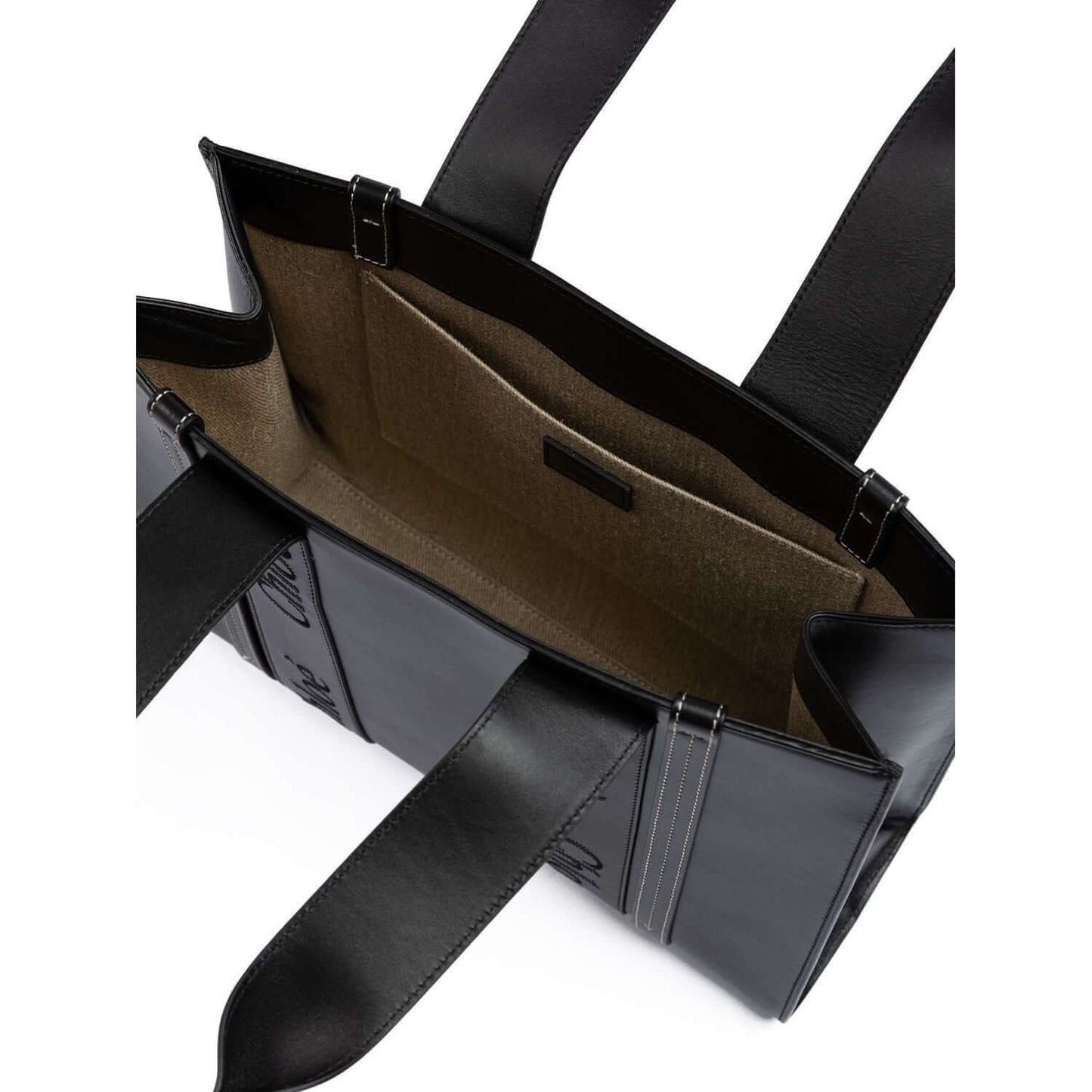 Interior view of Chloé Black Woody Embroidered Logo Leather Medium Tote Bag showcasing spacious compartments and leather handles.