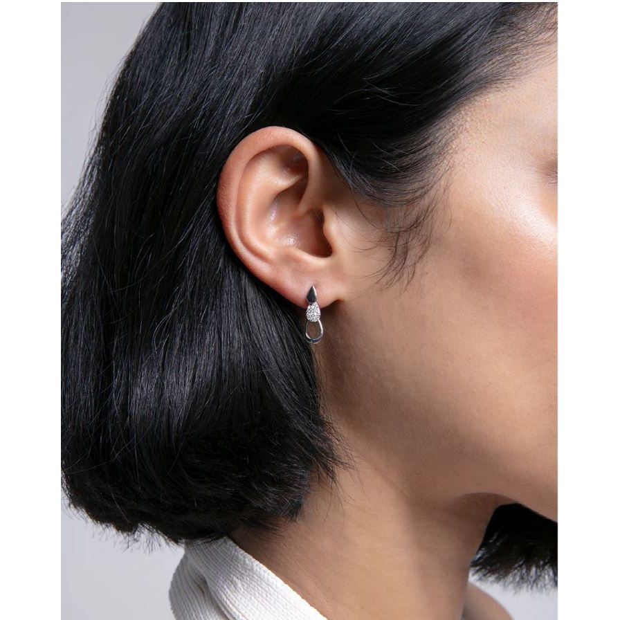 Woman wearing VICEROY JEWELS Mod. 13210E000-30 silver earrings, quartz movement, water resistant, multifunction, elegant design.