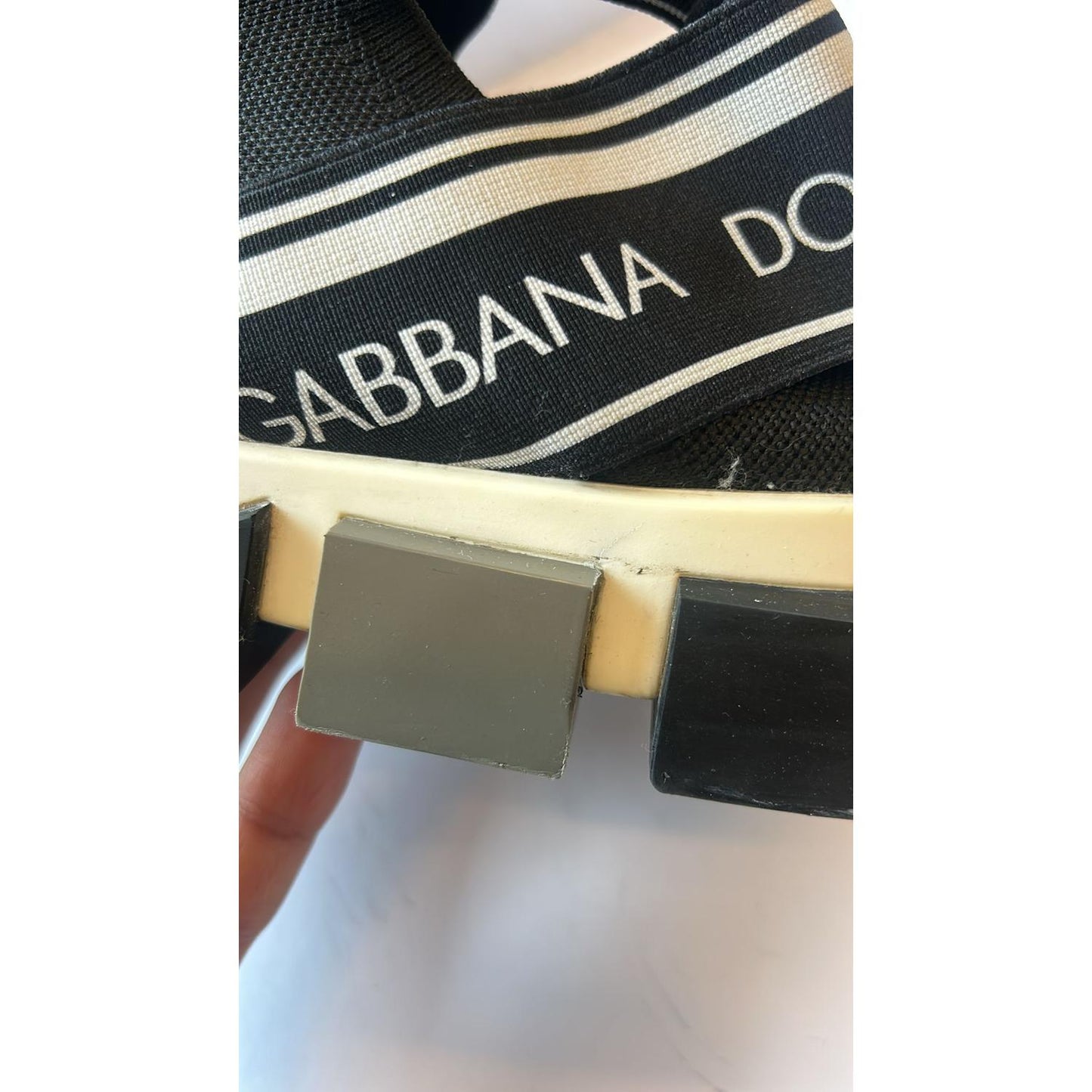 Close-up of Dolce & Gabbana Sorrento sneaker with logo print and black decorative rubber sole.